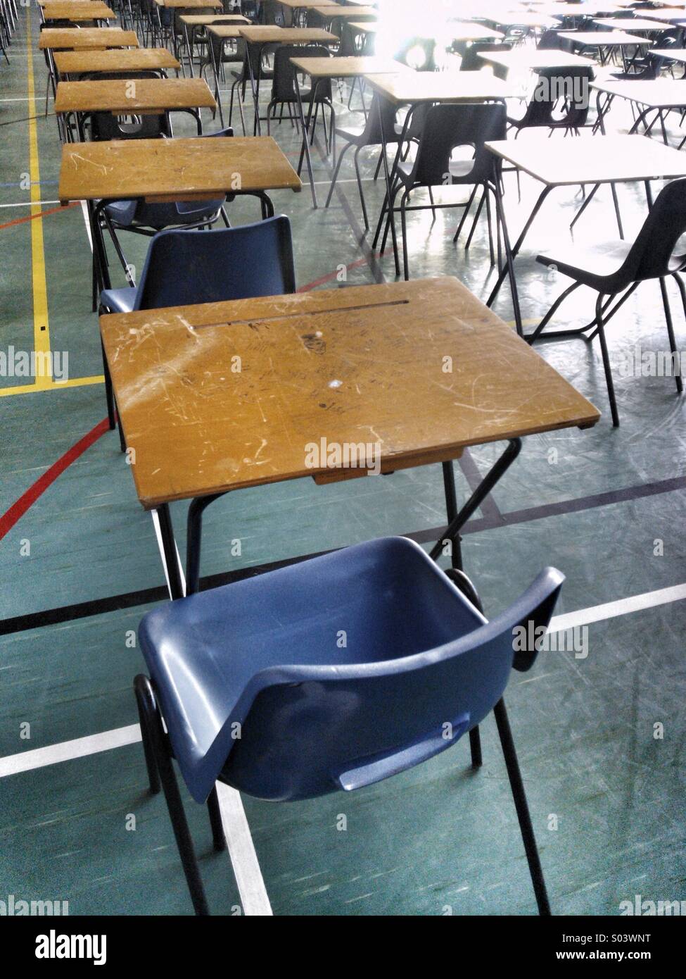 Rows of empty school exam desks in exam room hall. Stock Photo