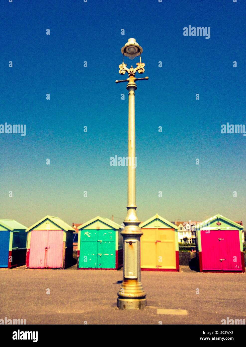 Beach huts at seaside with lamppost Stock Photo