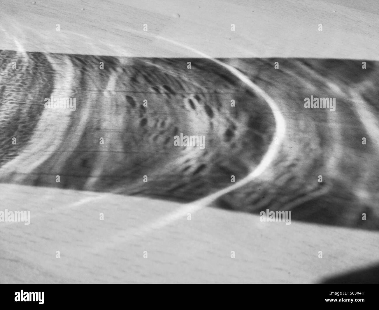 Reflection of a pint glass in the sun Stock Photo