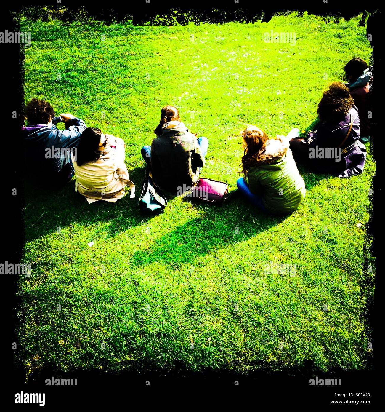 Women sitting on the lawn in a semi circle - Smartphone Captured Stock Image