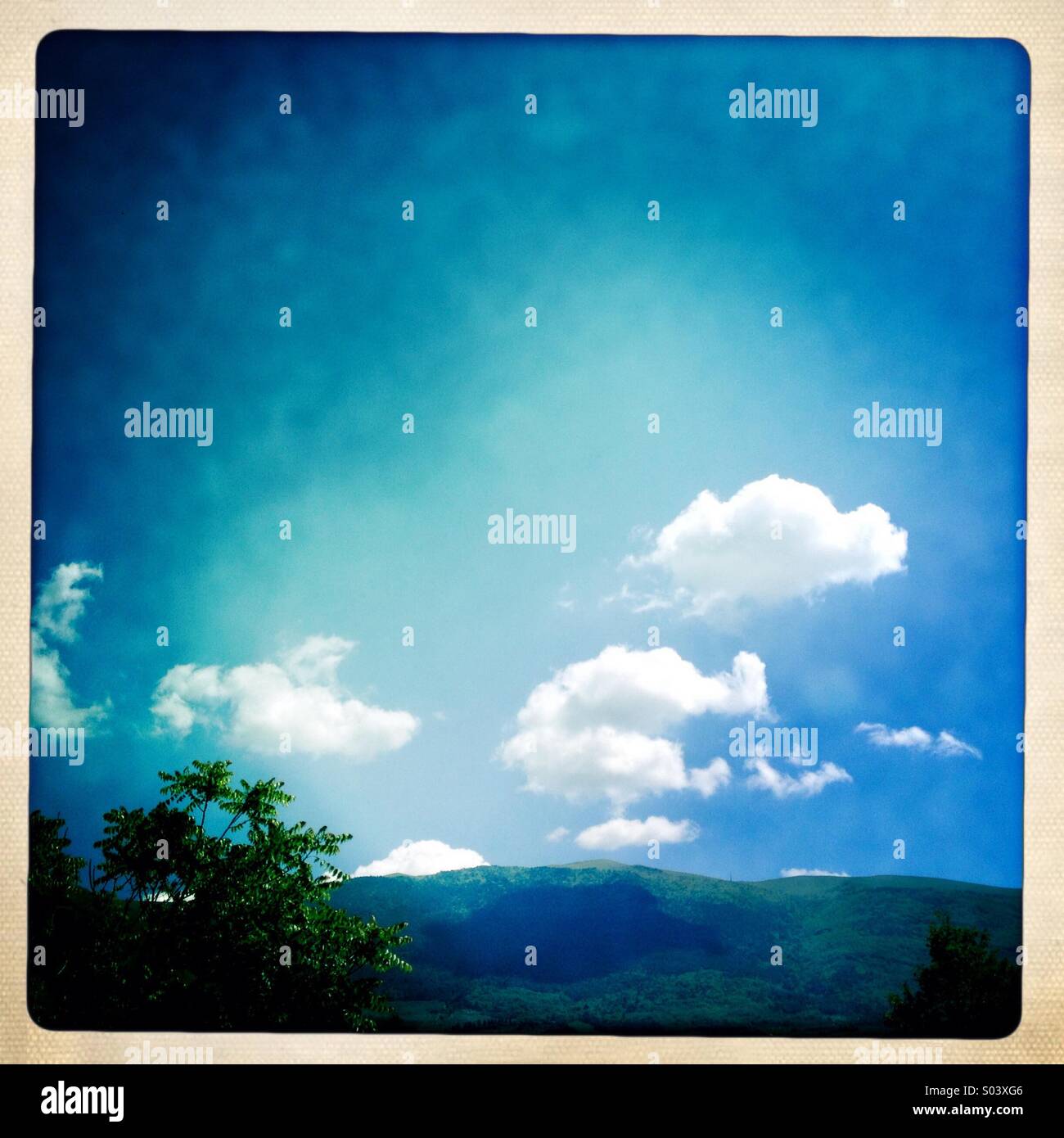 Mount Subasio in Umbria, Italy, with blue sky and white clouds - Smartphone Captured Stock Image
