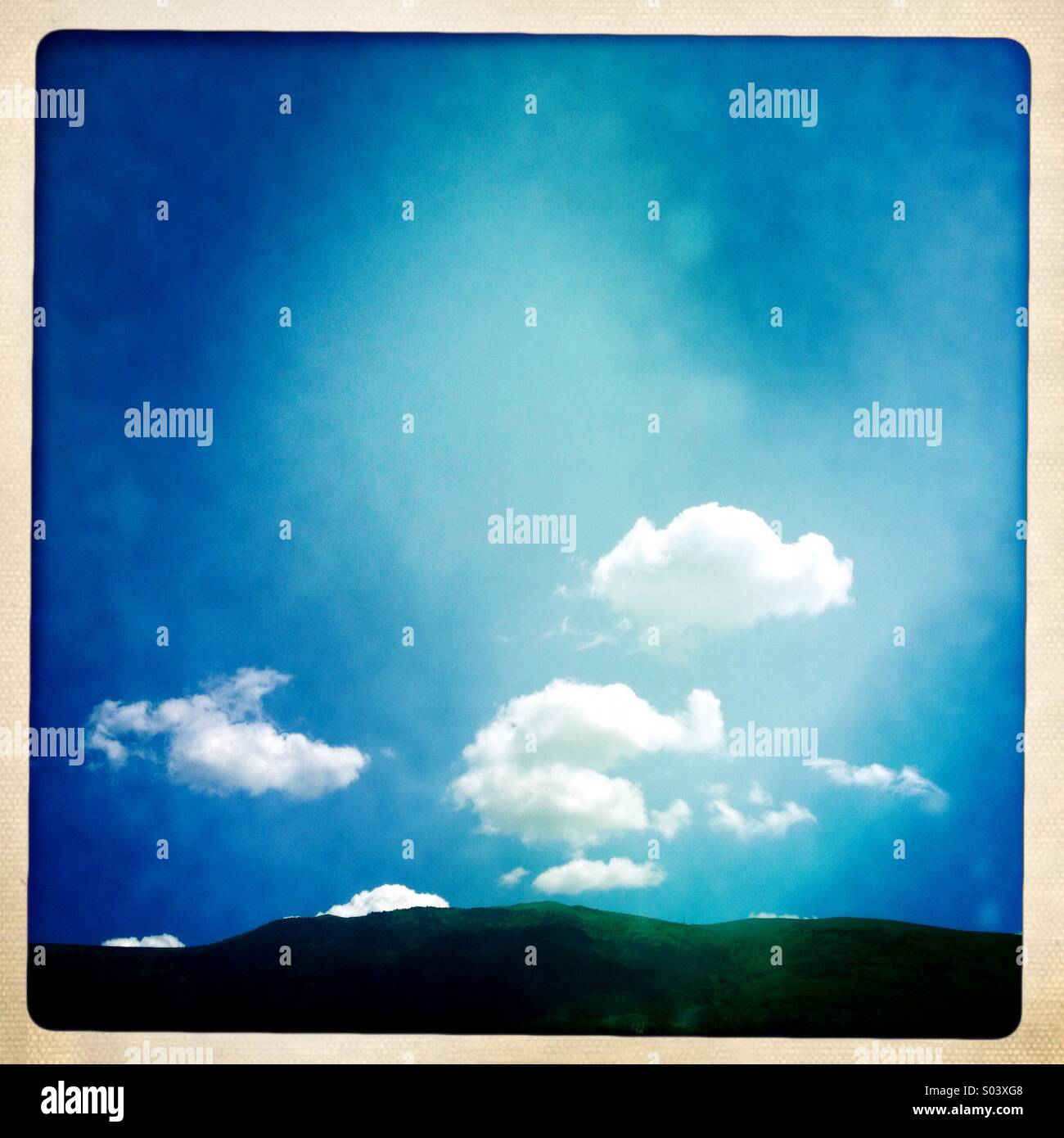 Mount Subasio in Umbria, Italy, with blue sky and white clouds - Smartphone Captured Stock Image