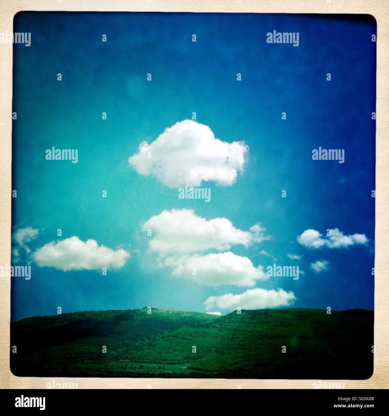 Mount Subasio in Umbria, Italy, with blue sky and white clouds - Smartphone Captured Stock Image