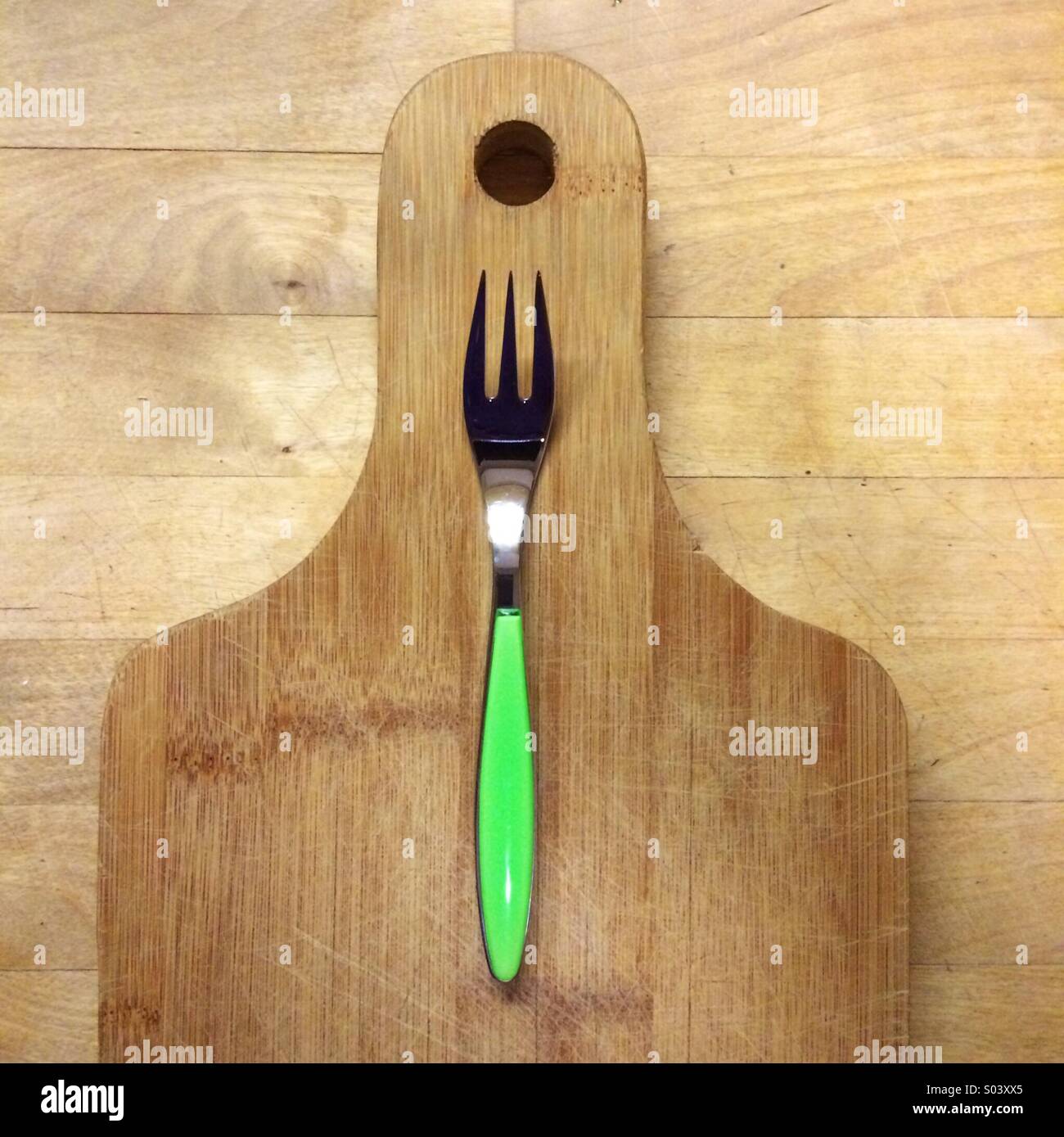 green fork on wooden cutting biard Stock Photo Alamy