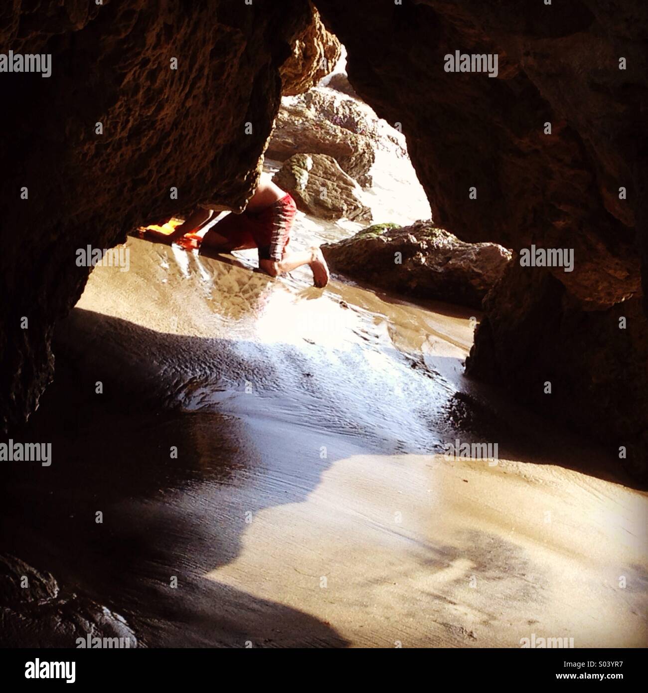 Exploring the Sea Cave Stock Photo