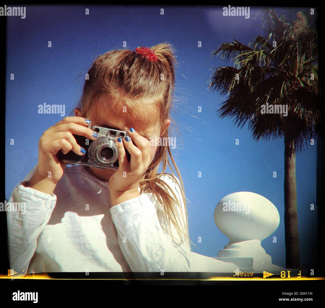 Six year old girl taking photograph with vintage camera Stock Photo Alamy