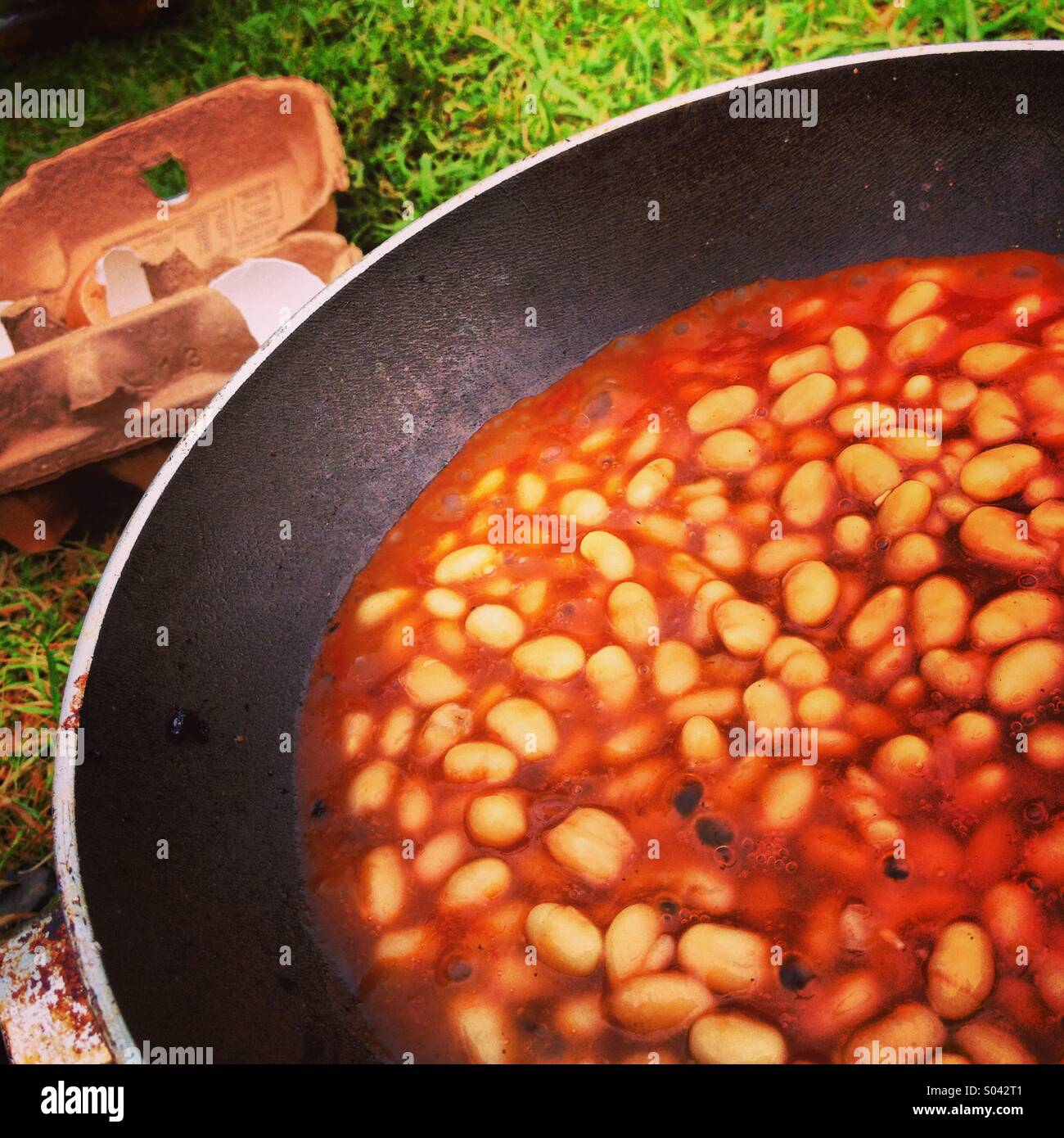 Baked beans being cooked outdoors. Stock Photo
