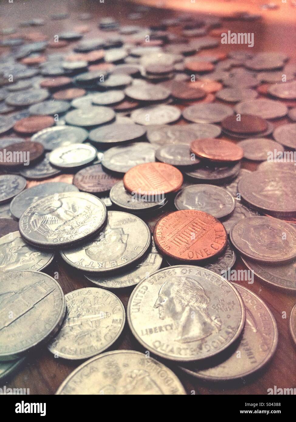 A large pile of coins - quarters, dimes, nickels, pennies Stock Photo