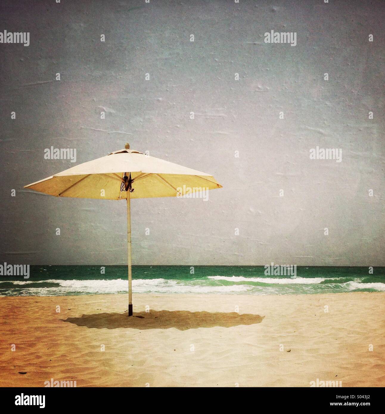 An umbrella on the beach. Abu Dhabi. United Arab Emirates Stock Photo ...