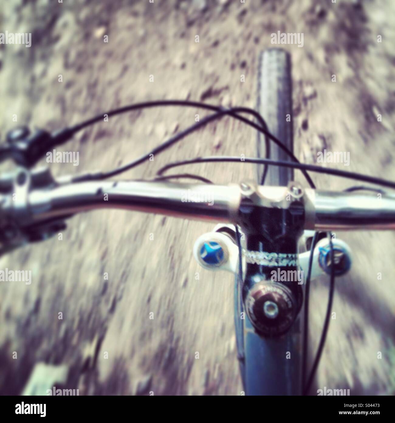 Riders view of a mountain bike travelling at speed along a trail. Stock Photo