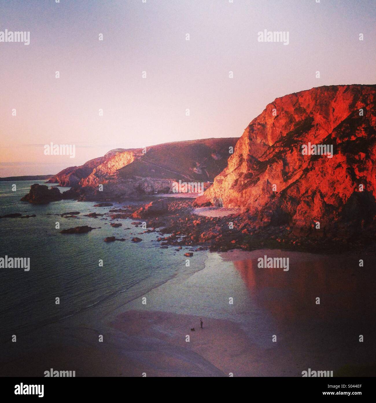 Cliffs glow red at sunset on Cornwall's north coast at St Agnes. - Smartphone Captured Stock Image