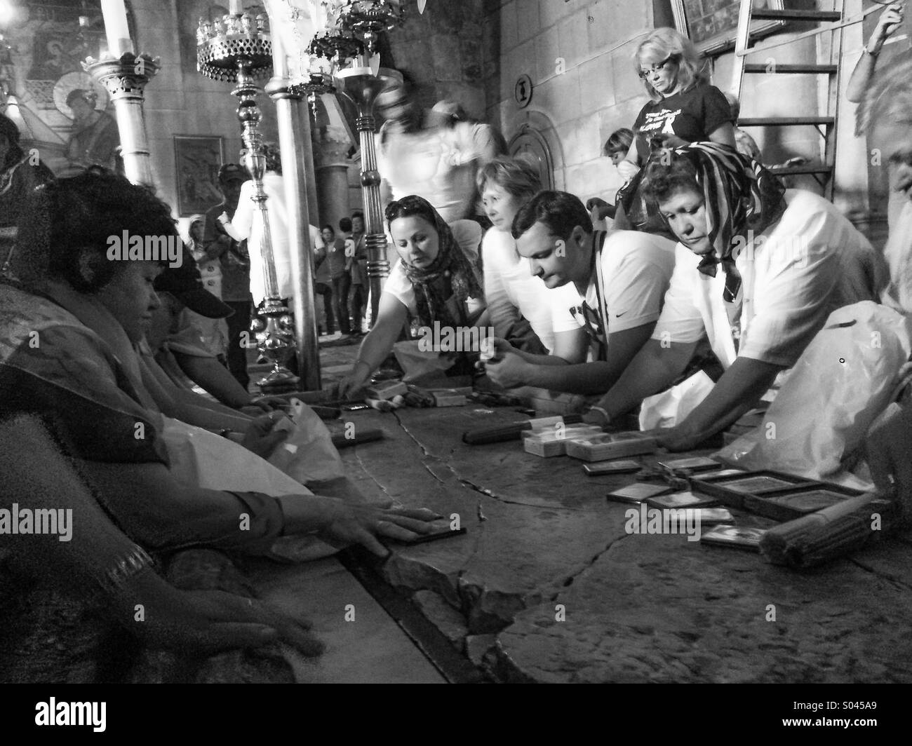 Pilgrims over the stone of anointing at the Church of the Holy Sepulcher, Jerusalem - Smartphone Captured Stock Image