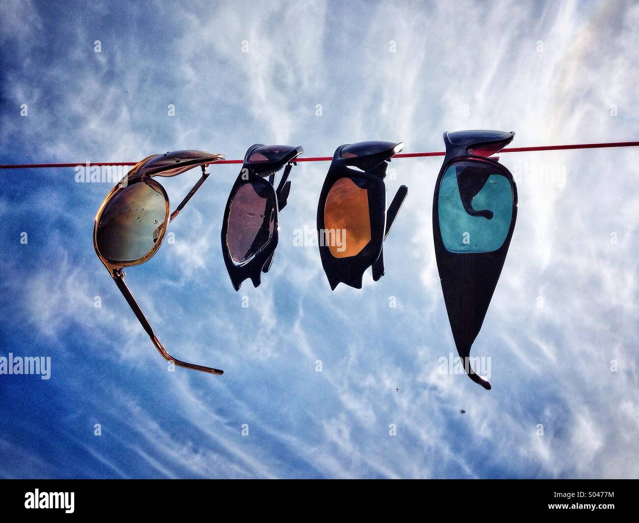 Sunglasses hanging on a washing line Stock Photo