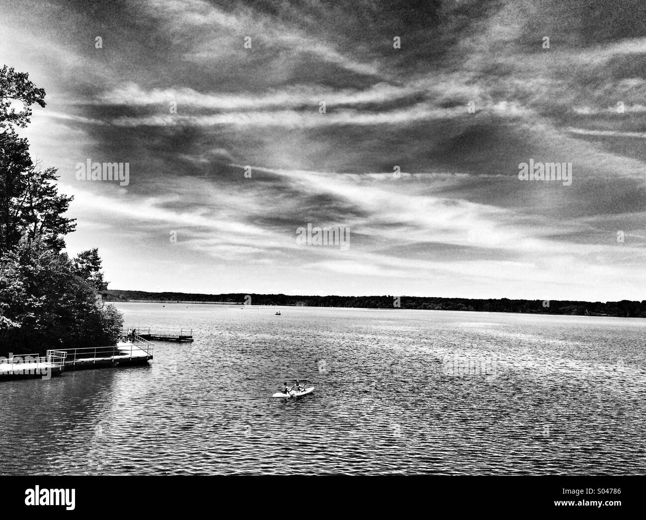 Canoe in lake on Black and White Stock Photos & Images - Alamy