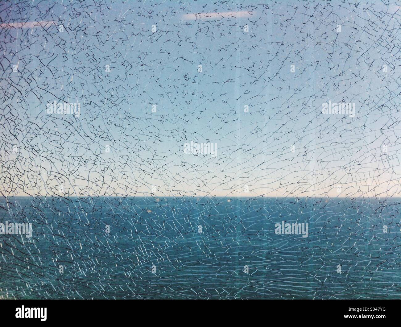 View of the Mediterranean sea through  a broken glass. Stock Photo