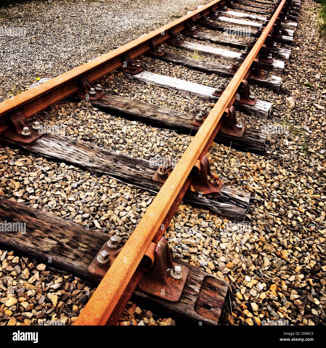 Disused rusty train tracks and sleepers. Stock Photo