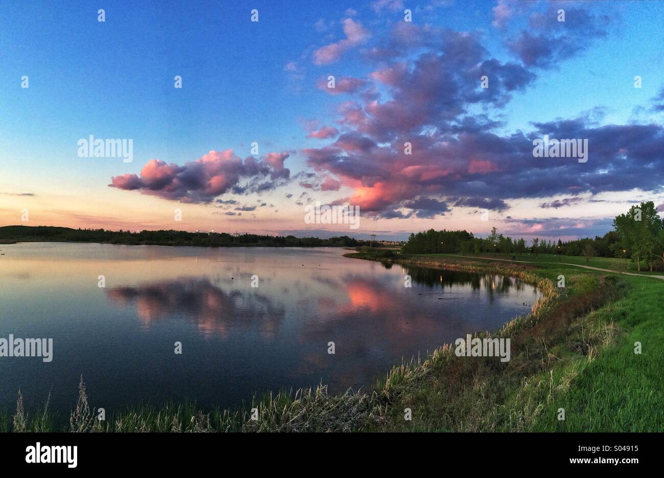 Miniature clouds and their reflection over wascana Stock Photo
