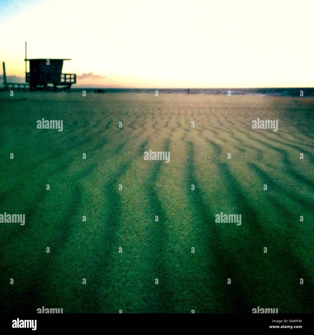 Lifeguard tower on the beach and line patterns in the sand. Manhattan beach California. USA - Smartphone Captured Stock Image