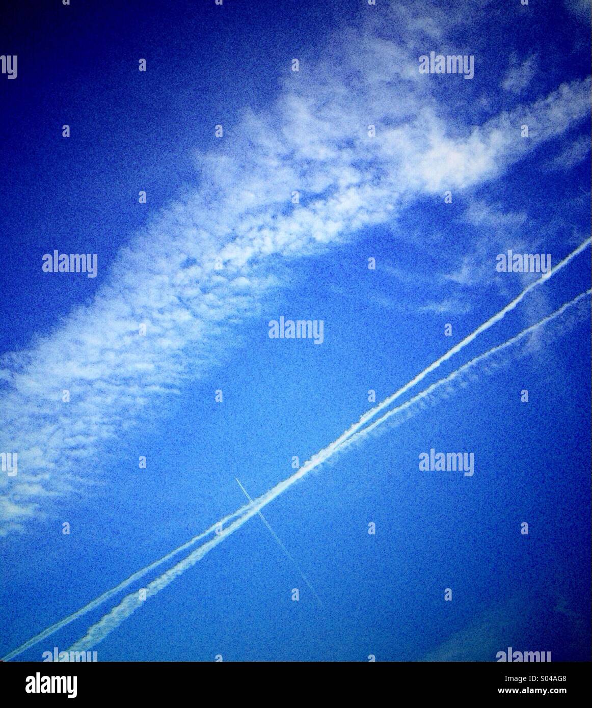 Contrail cross and cloud - Smartphone Captured Stock Image