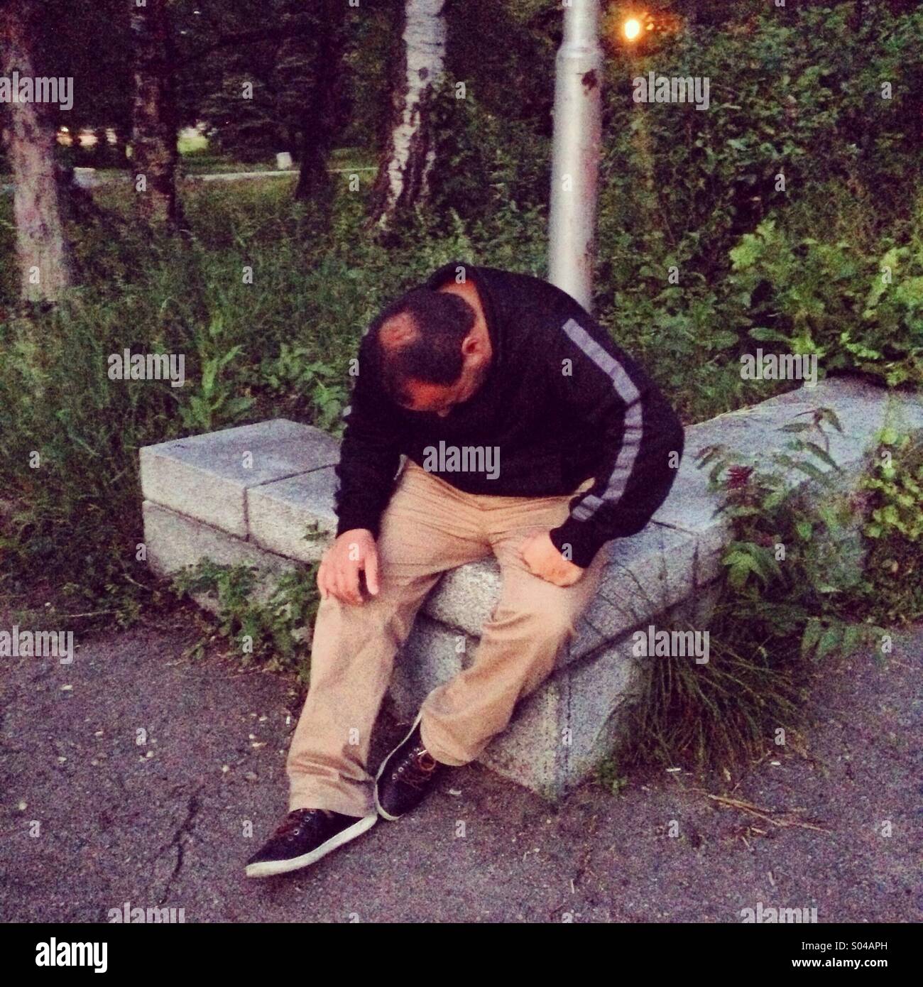 Exhausted man in park, Boris gardens, Sofia, Bulgaria - Smartphone Captured Stock Image