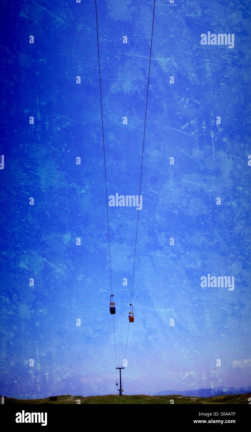 Cable cars against blue sky Stock Photo - Alamy