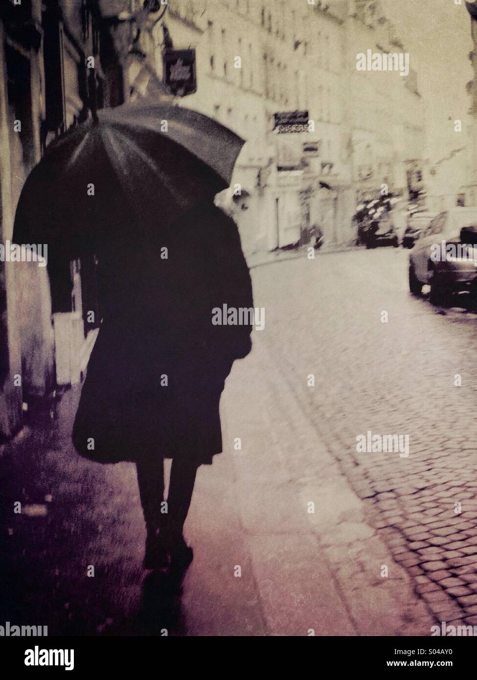 Woman with umbrella on the steets of Paris - Smartphone Captured Stock Image
