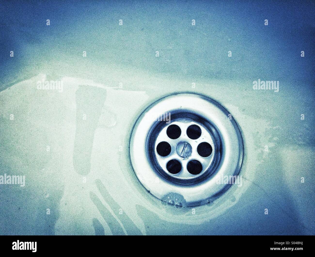 Water running the plug hole in a bathroom sink - Smartphone Captured Stock Image