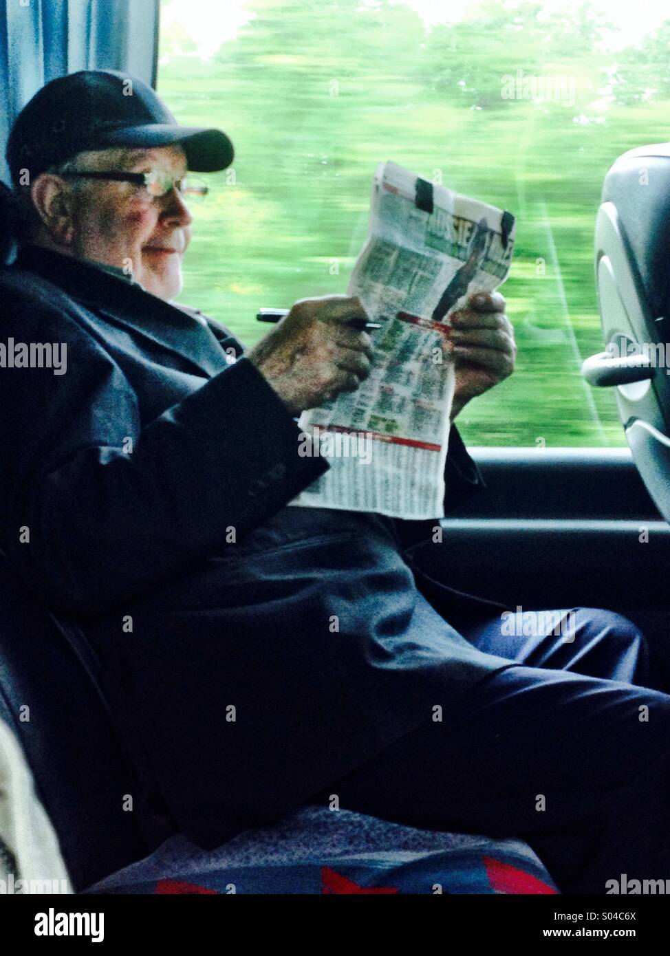 Man and Racing newspaper - Smartphone Captured Stock Image