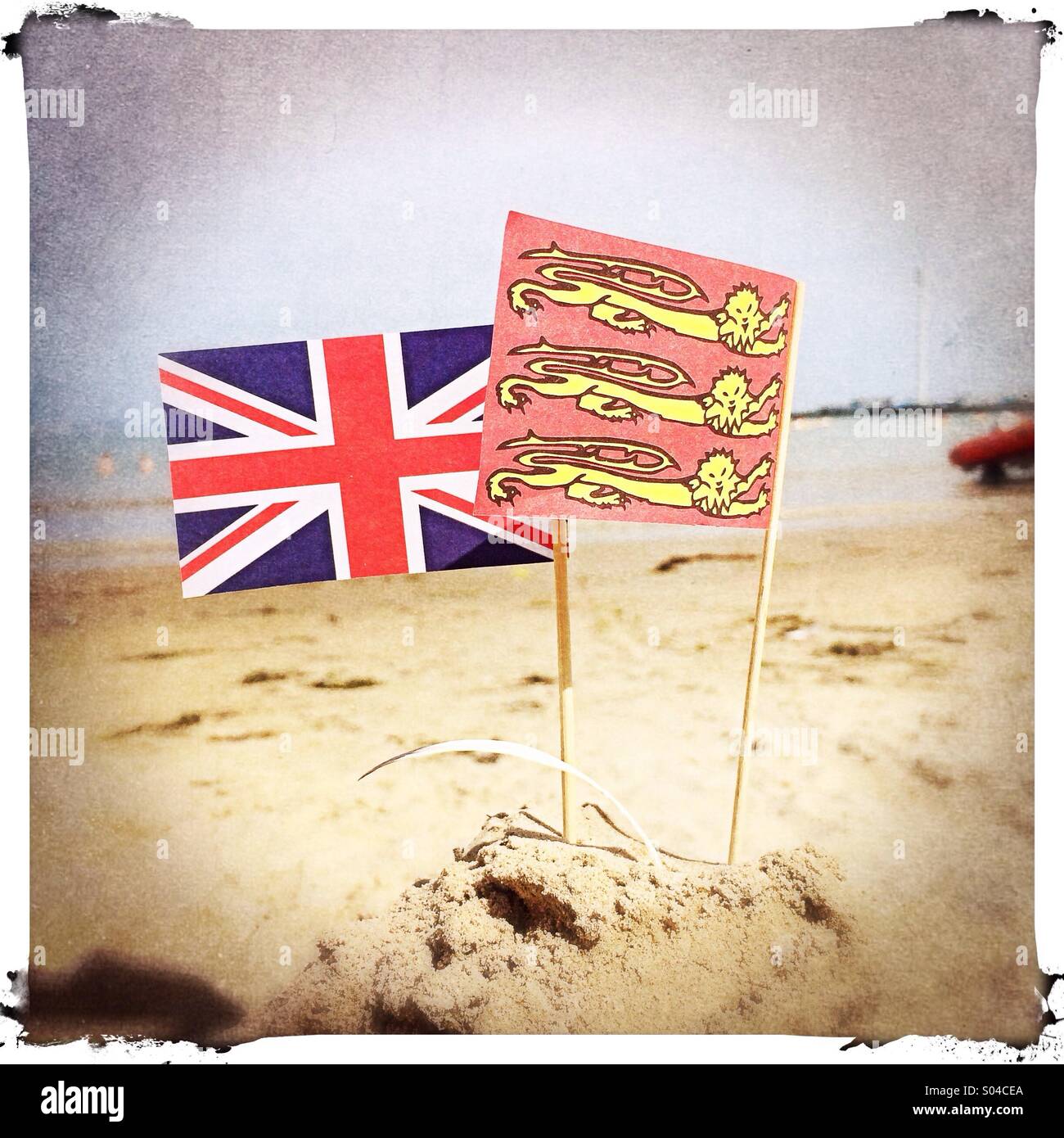 Flags on a sandcastle on the beach, UK Stock Photo Alamy