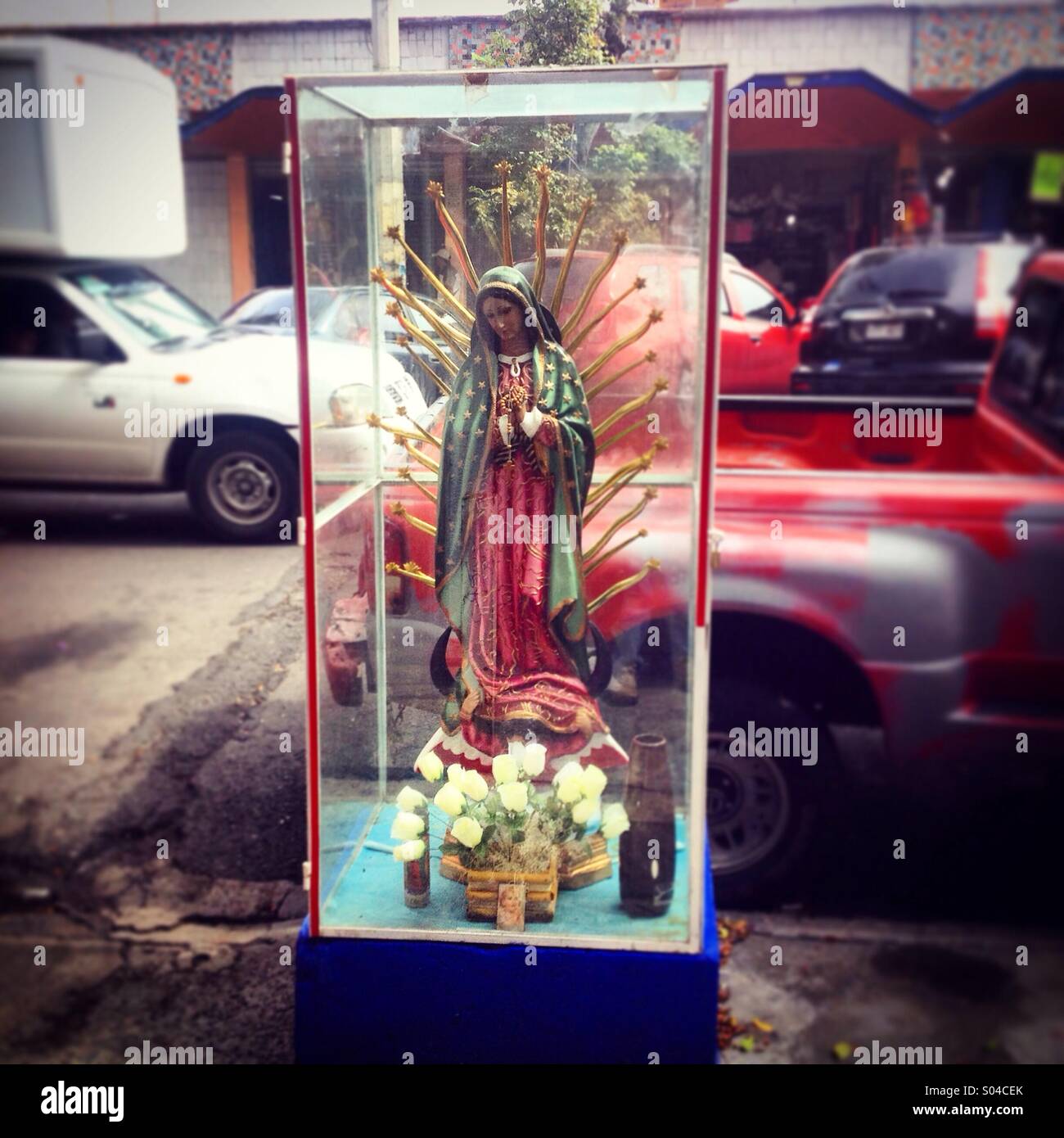 An altar with an sculpture of the Virgin of Guadalupe is displayed outside of Medellin Market, Colonia Roma, Mexico City, Mexico - Smartphone Captured Stock Image