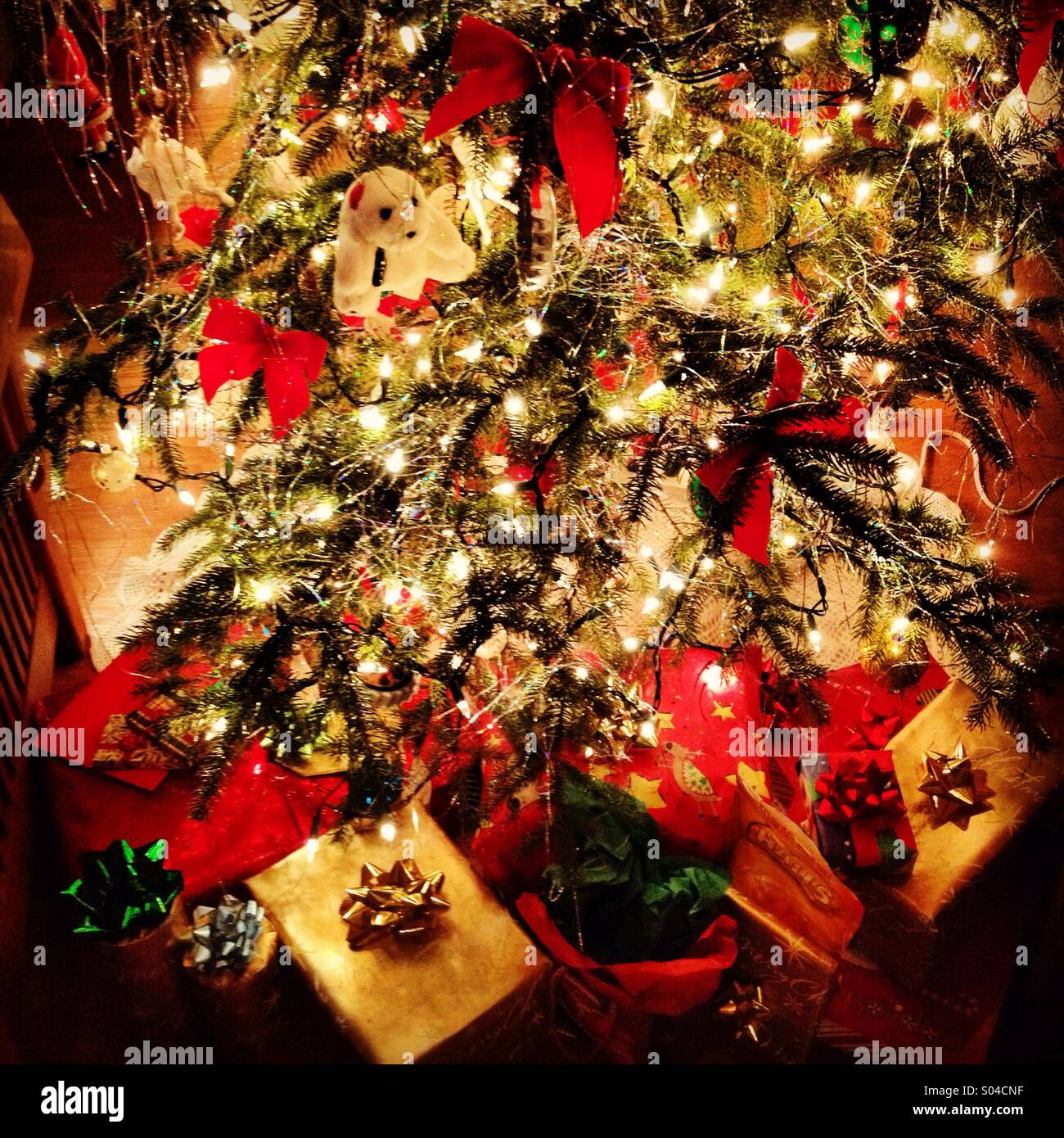 Christmas tree with gifts underneath. Stock Photo
