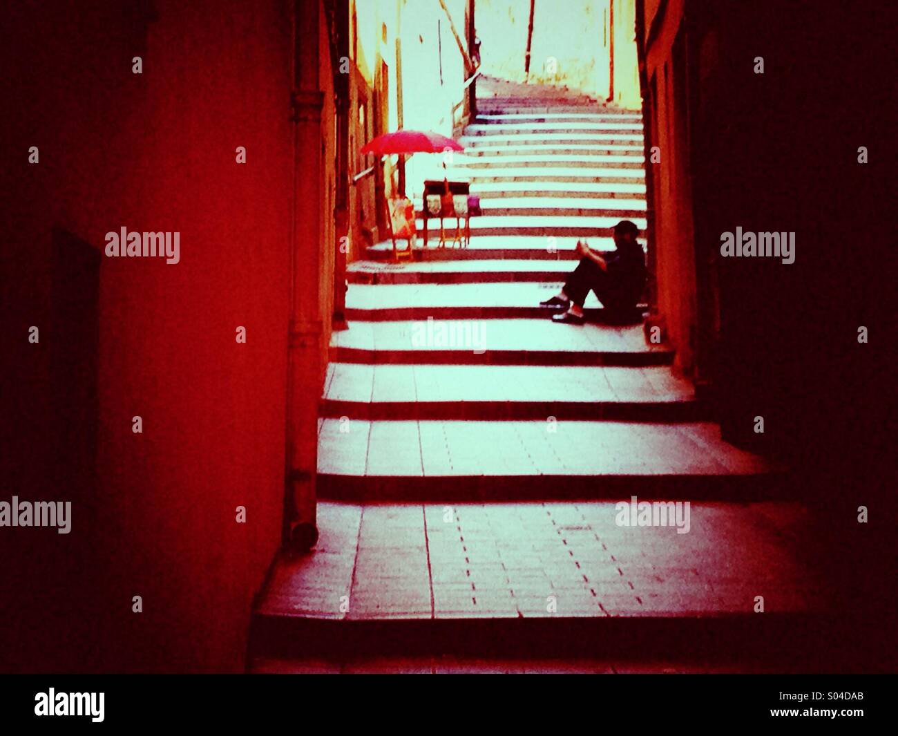 Man sitting on a stairway in Old Town, Nice - Smartphone Captured Stock Image