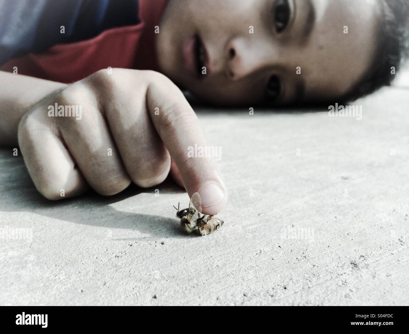 6 year old boy pretending to be in shock from a bee sting - Smartphone Captured Stock Image