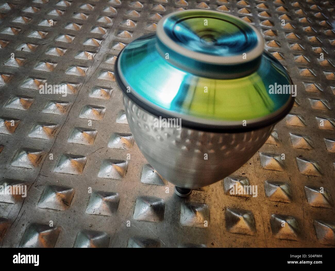 Spinning top turning. Colorful whirligig - Smartphone Captured Stock Image