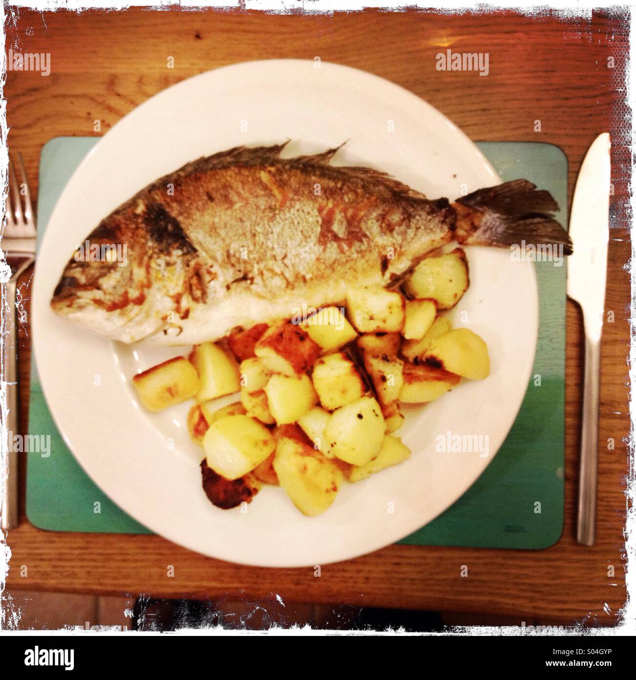 A plate of fried fish and potatoes - Smartphone Captured Stock Image