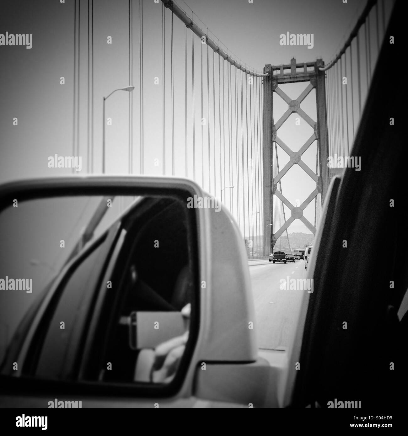 Distracted driver taking a picture of the Bay Bridge while driving. San Francisco, California, USA Stock Photo