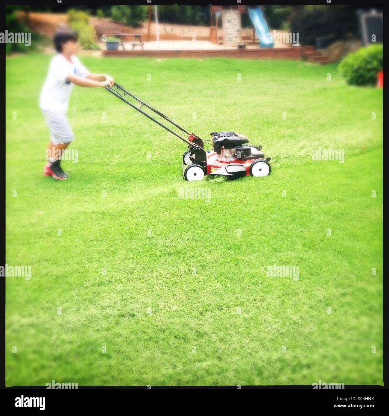 Little boy cutting grass Stock Photo Alamy