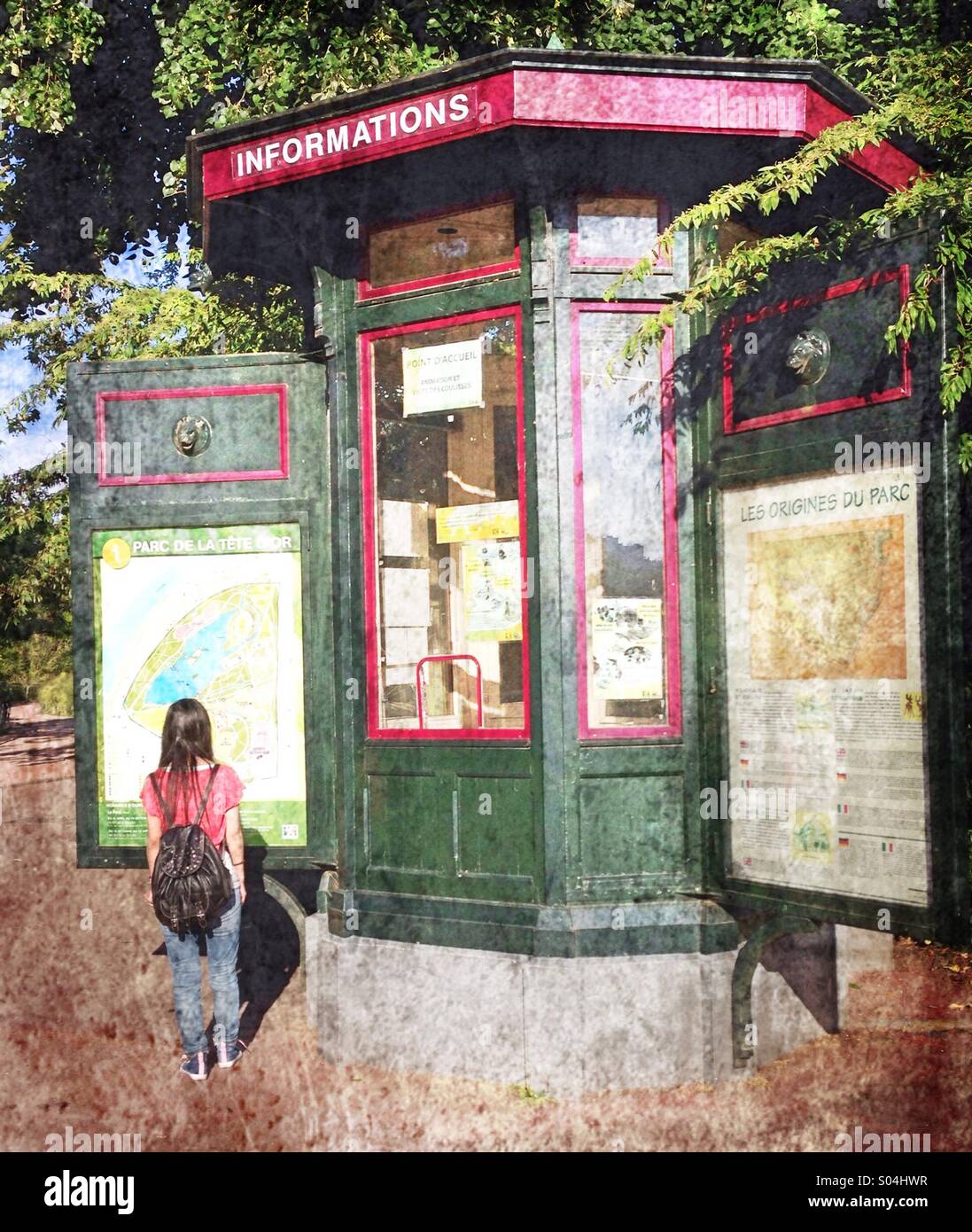 A young woman looking a park map, Lyon,France - Smartphone Captured Stock Image
