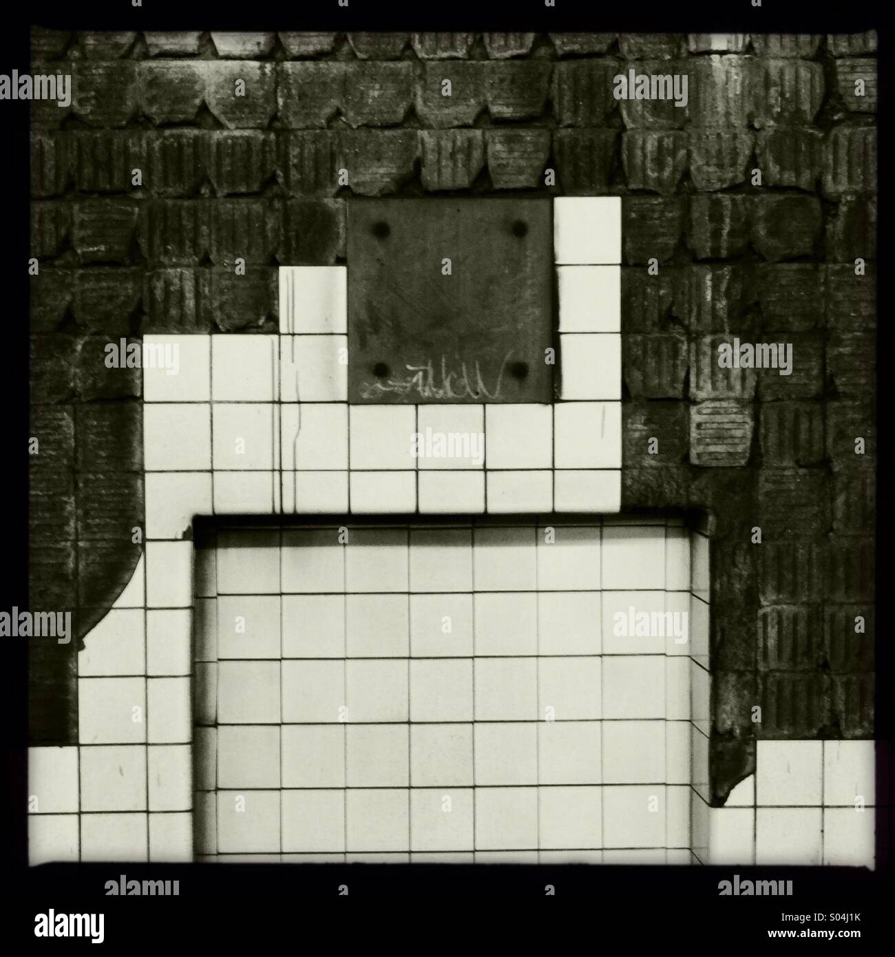 Subway. Wall of the tunnel at the 21st station of the G line in Queens, NY. Tiles are falling off leaving interesting designs in the wall - Smartphone Captured Stock Image