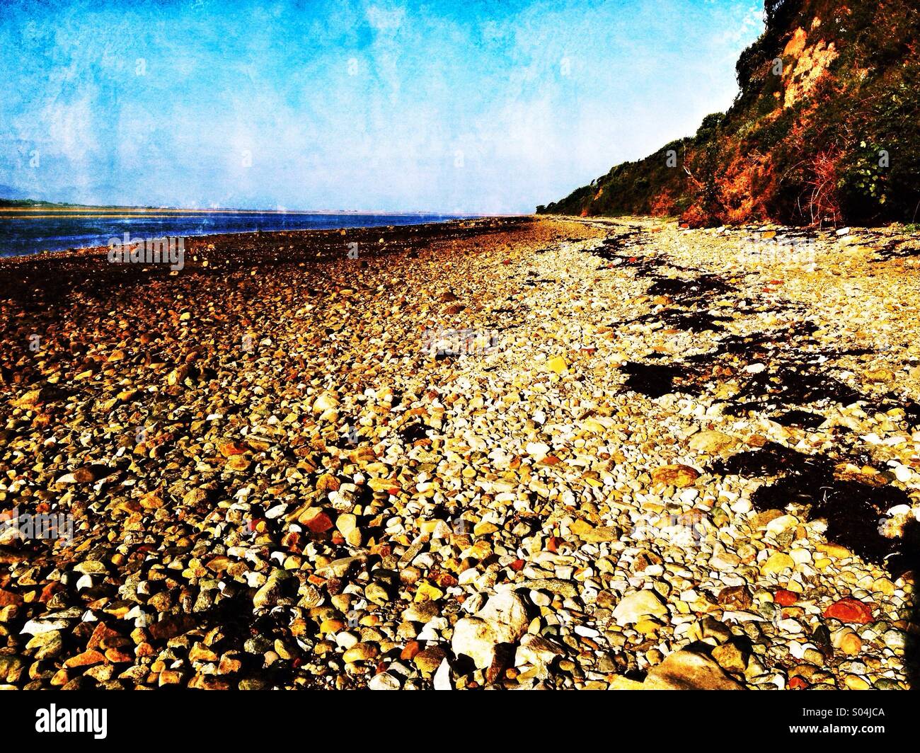 Shingle beach by Menai Strait on Anglesey Stock Photo