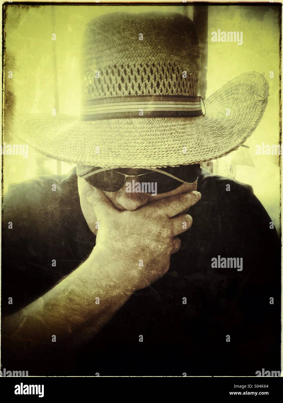 Man in a woman's summer hat - Smartphone Captured Stock Image