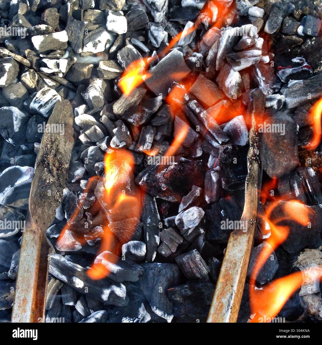 BBQ coals and tongs - Smartphone Captured Stock Image