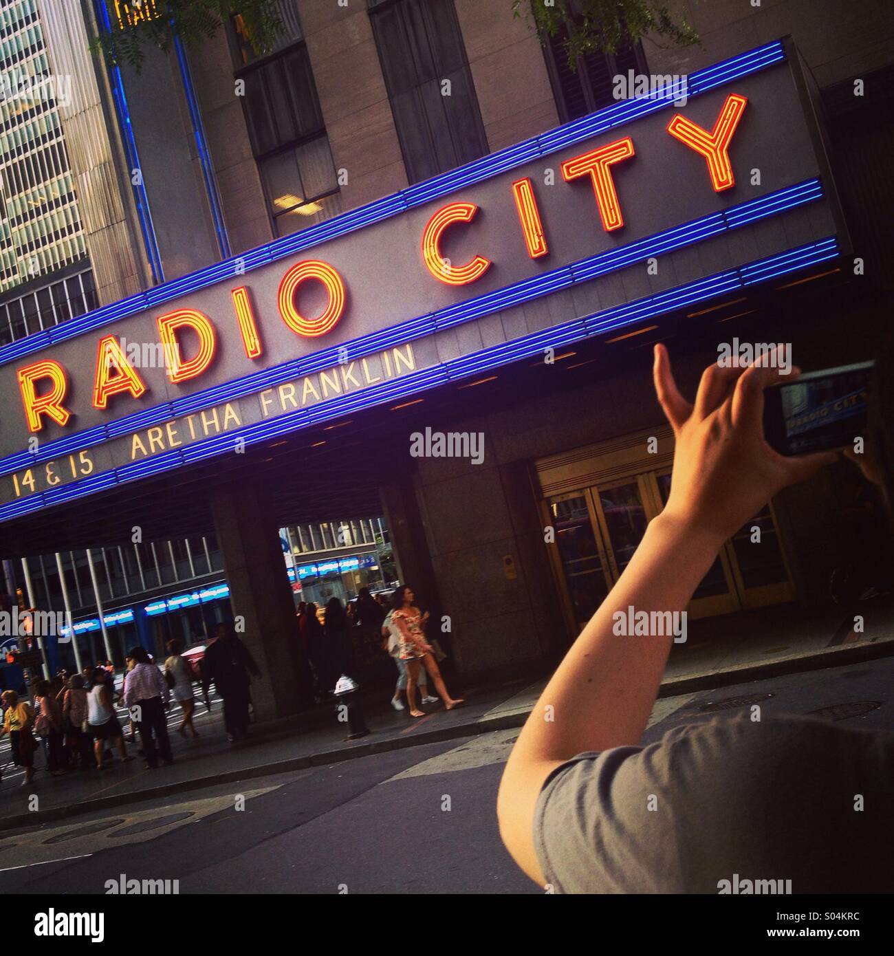 Tourist photographing Radio City Music Hall, Manhattan, New York, America. Stock Photo