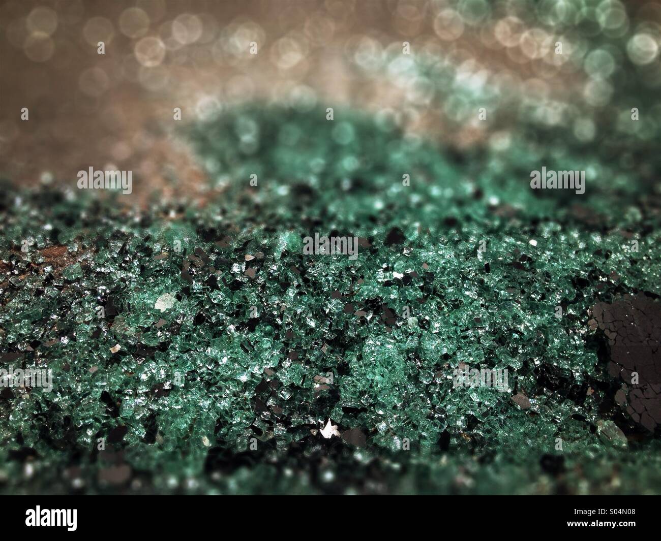 Smashed glass windshield on asphalt road. - Smartphone Captured Stock Image