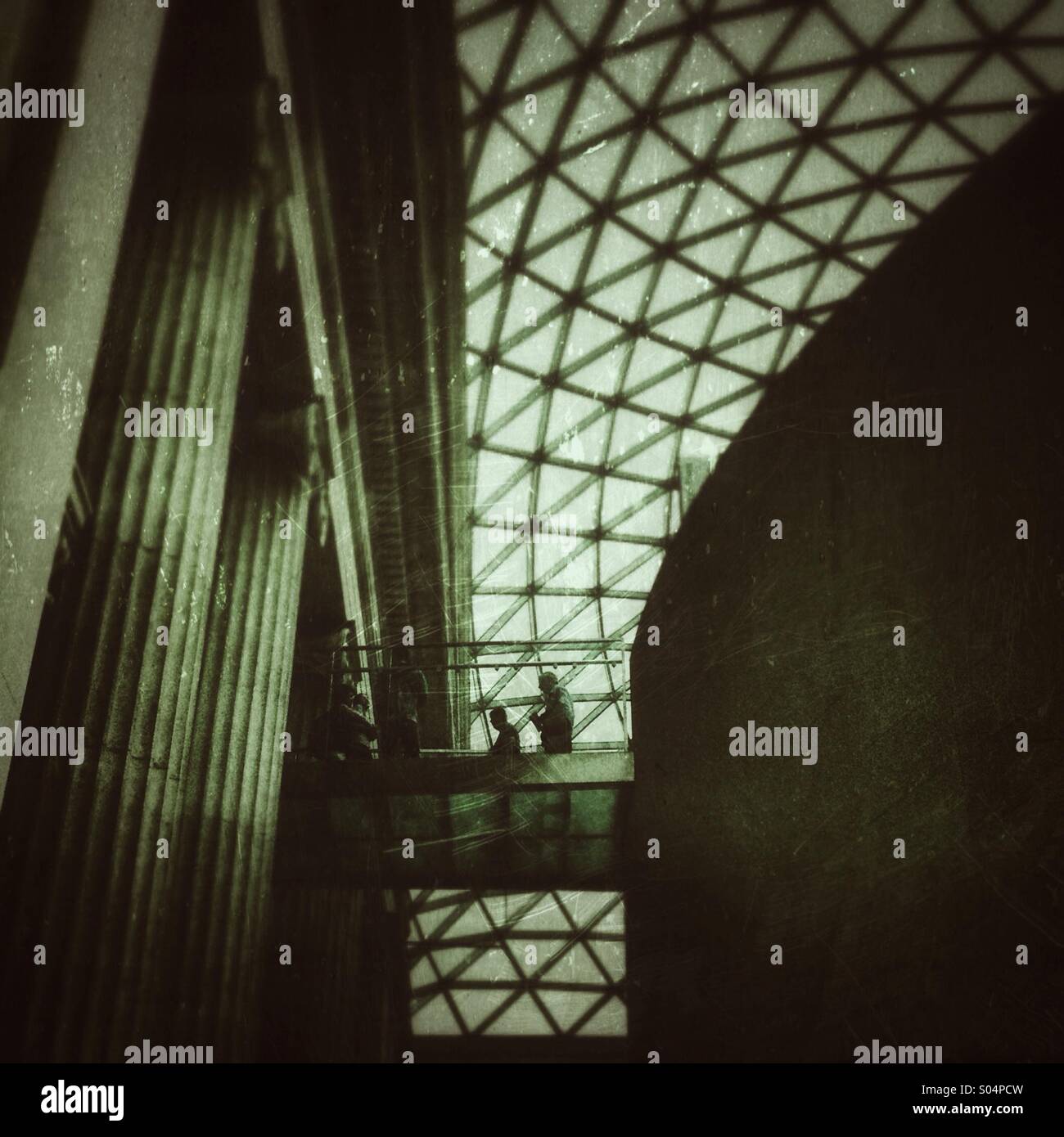Visitors on a glass walkway high above the great hall in the British Museum, London - Smartphone Captured Stock Image