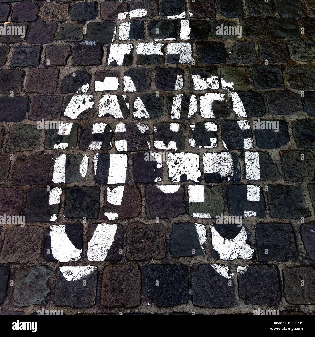 Bicycle Lane white sign on the cobblestone pavement. - Smartphone Captured Stock Image
