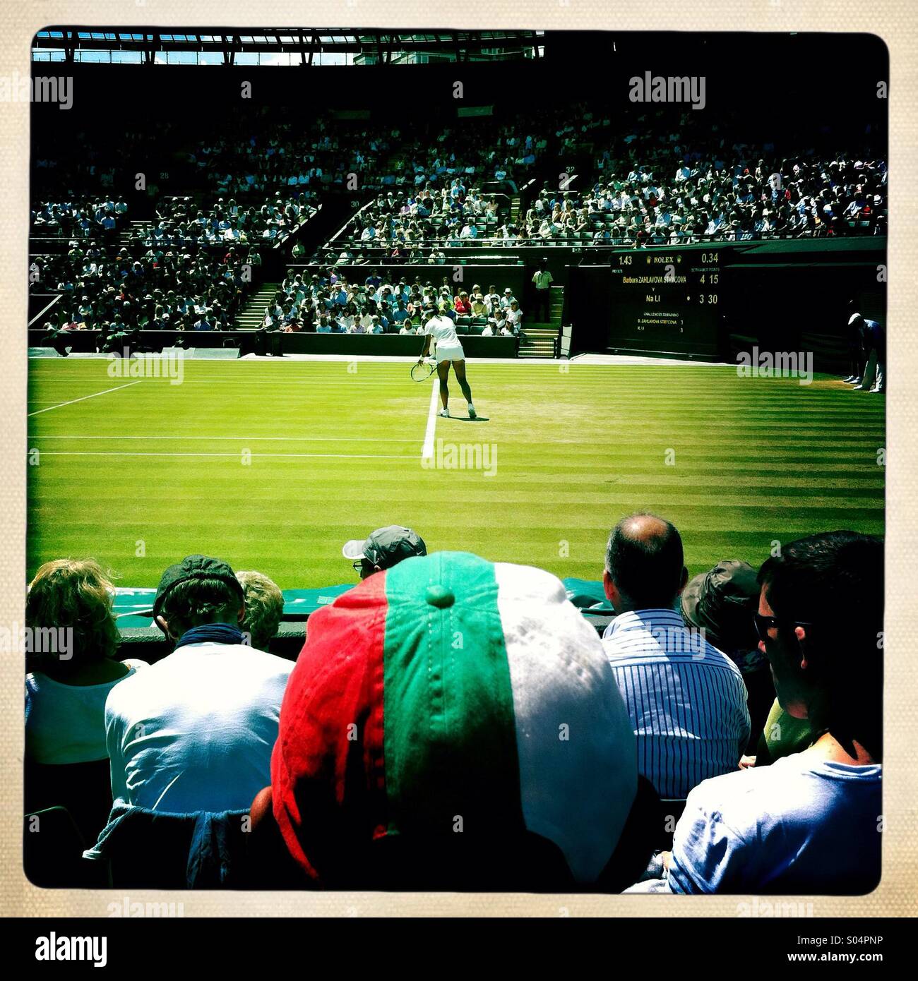 Boy in Bulgaria cap watching tennis at Wimbledon Stock Photo