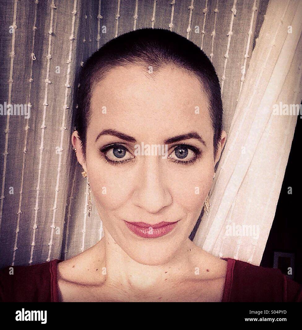 Woman with shaved head Stock Photo
