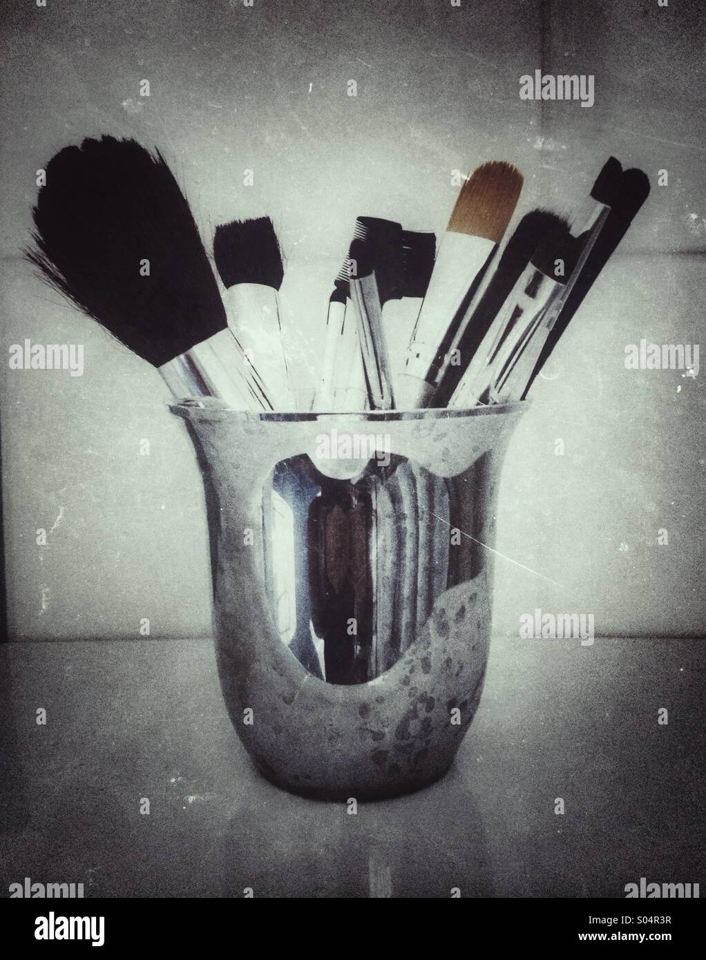 An aluminium tumbler with cosmetics brushes - Smartphone Captured Stock Image