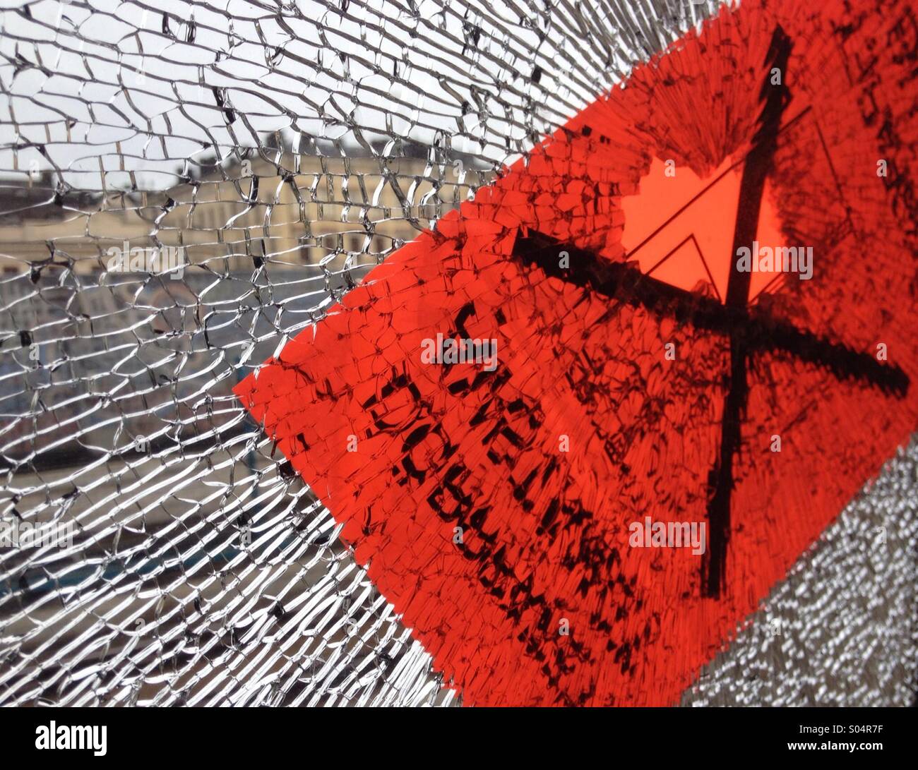 Broken laminated window with hole and sticker - Smartphone Captured Stock Image